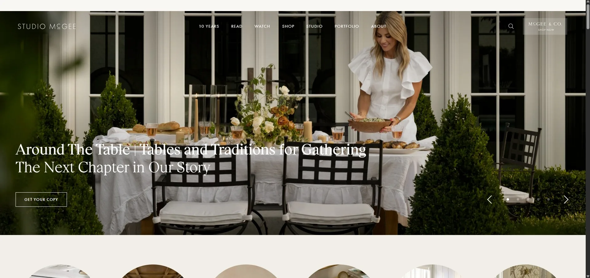 Studio McGee website homepage showing designer Shea McGee setting an elegant outdoor dining table for a gathering.